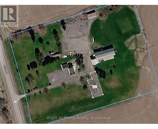 A satellite image of a property with a house, a garage, and a driveway.