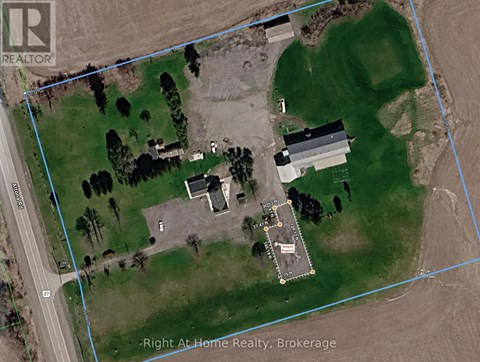 A satellite image of a property with a house, a garage, and a driveway.