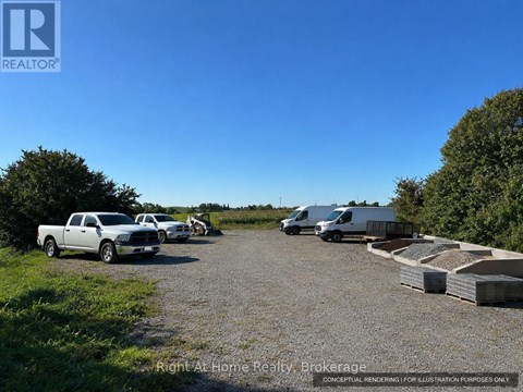 A gravel lot with a truck, a van, and a trailer.