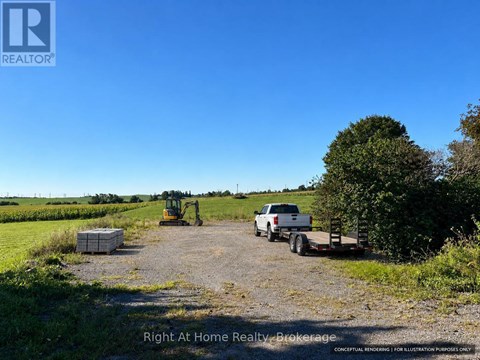 A dirt road with a white truck and a yellow tractor.