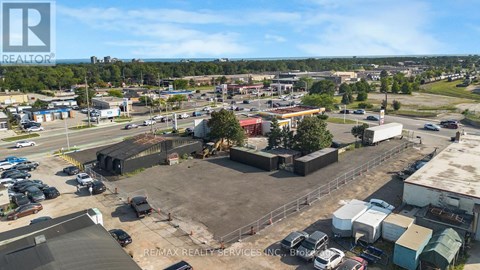 A large outdoor parking lot with a building in the background.