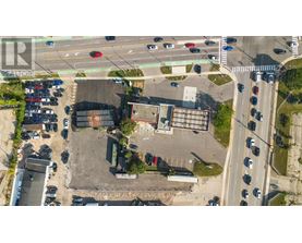 A parking lot with cars and a building in the background.