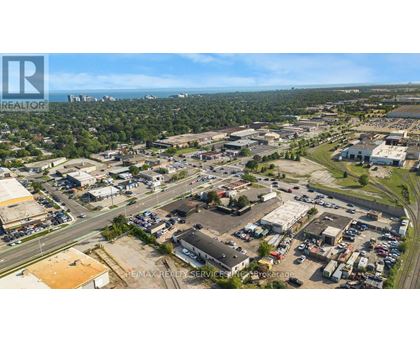 An aerial view of a commercial area with a parking lot and buildings.
