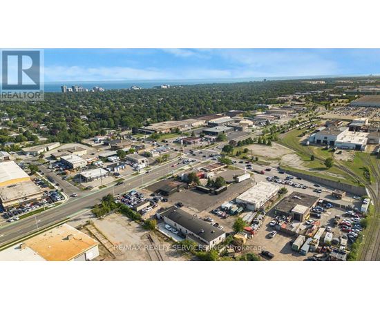 An aerial view of a commercial area with a parking lot and buildings.