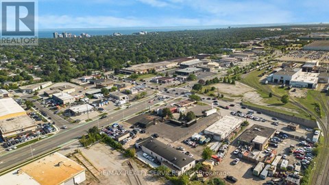 An aerial view of a commercial area with a parking lot and buildings.