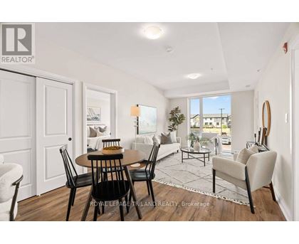 A well-lit, spacious living room with a dining table and chairs.