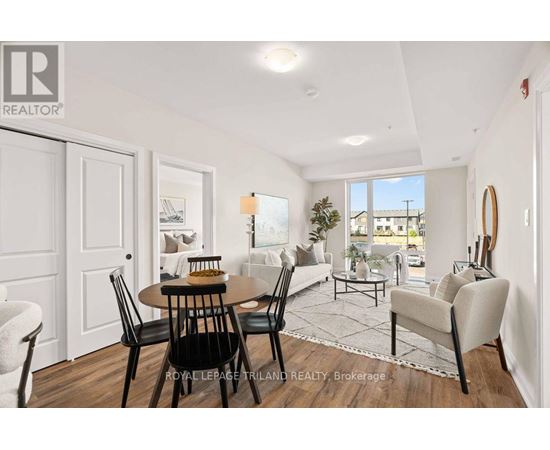 A well-lit, spacious living room with a dining table and chairs.