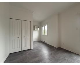A room with a slanted ceiling and a large white door.