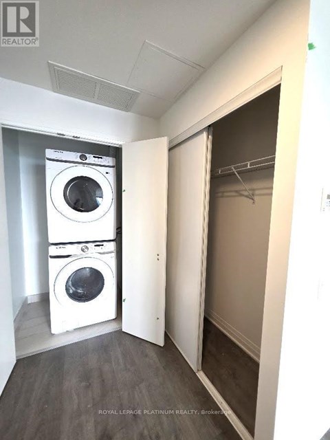 A laundry room with a washer and dryer stacked on top of each other.