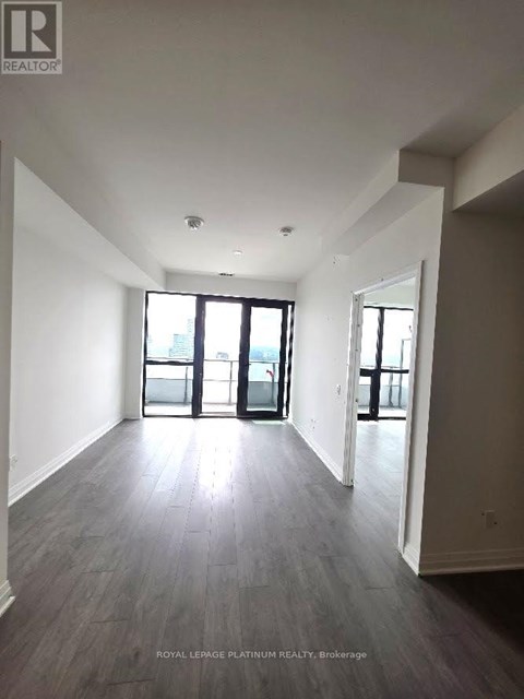 A spacious room with a view of the city through the windows.