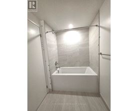 A white bathroom with a tub and a shower.