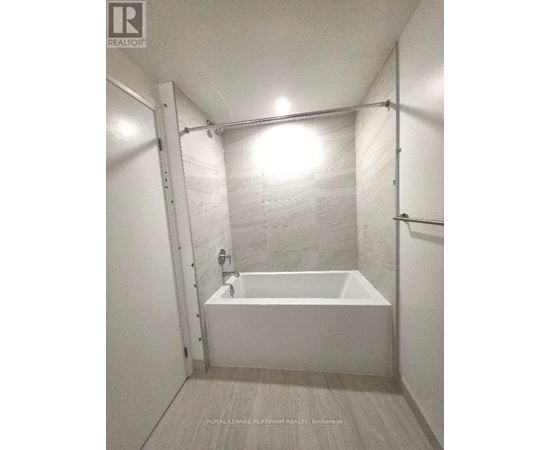 A white bathroom with a tub and a shower.