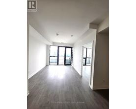 A spacious room with a large window and sliding glass doors.