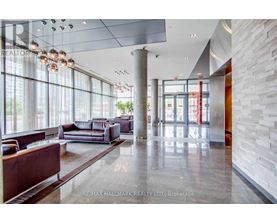 A spacious lobby with a marble floor and a large window.