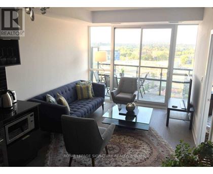 A living room with a sofa, chairs, and a coffee table.