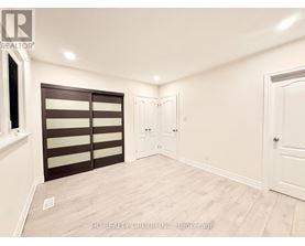 A room with a sliding door and a white door.