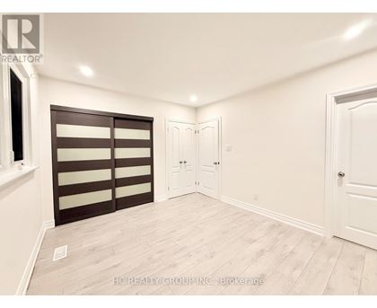 A room with a sliding door and a white door.