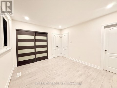 A room with a sliding door and a white door.