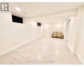 A spacious room with a couch and a window.
