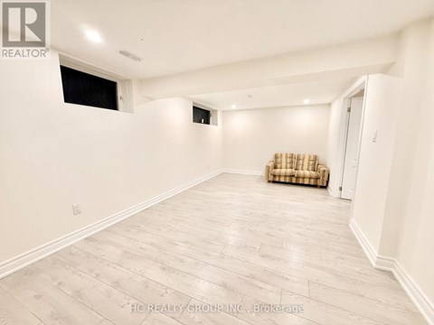 A spacious room with a couch and a window.
