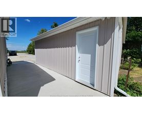 A white door is on the side of a building.