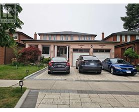 Three cars are parked in front of a house.