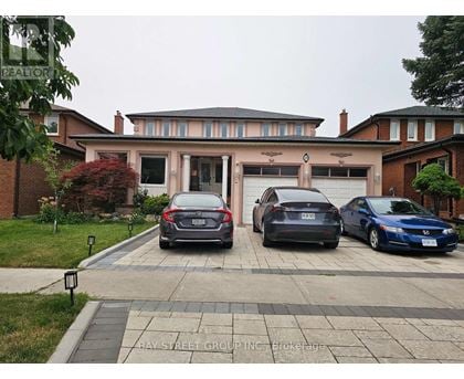 Three cars are parked in front of a house.