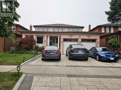 Three cars are parked in front of a house.