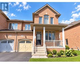 A two-story brick house with a front porch and two garages.