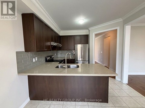 A kitchen with a sink and a counter.