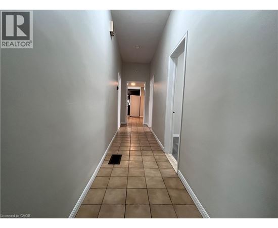 A long hallway with a door at the end.