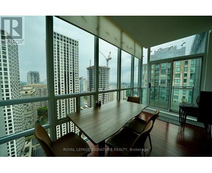 A dining room with a view of the cityscape.