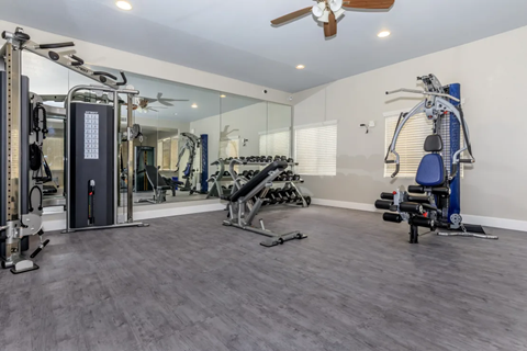 A spacious home gym with a variety of exercise equipment.