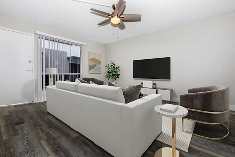 A modern living room with a white sofa and a television.
