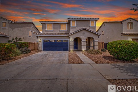 A house with a blue garage door is available for sale.