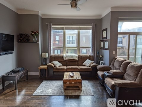 A living room with a brown sofa and a wooden coffee table.