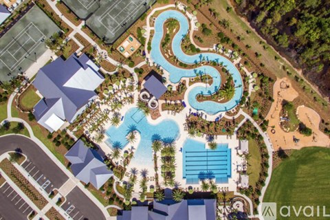 A bird's eye view of a resort with a large pool and a water slide.