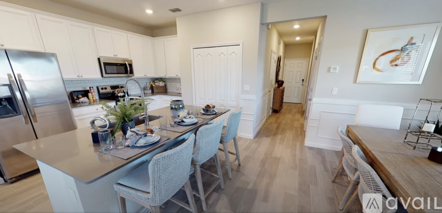 A kitchen with a table and chairs in the middle of it.