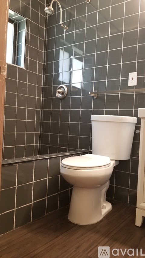 A white toilet in a tiled bathroom.