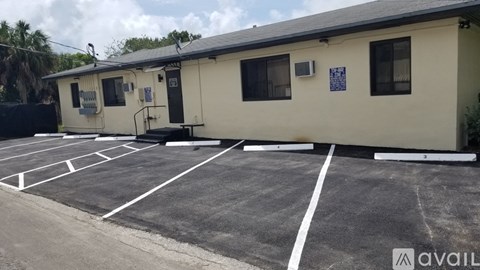 A parking lot with a building in the background.