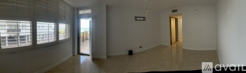 A room with a tiled floor and a door leading to a balcony.