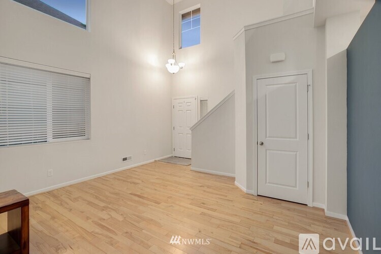 A room with wooden flooring and a white door.