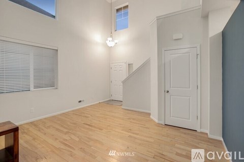 A room with wooden flooring and a white door.
