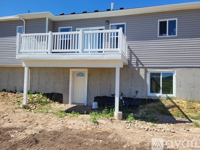 A two-story house with a balcony and a bicycle parked outside.