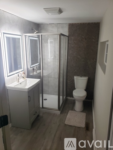 A bathroom with a toilet, sink, and shower.