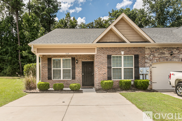 A house with a garage and a driveway in front.