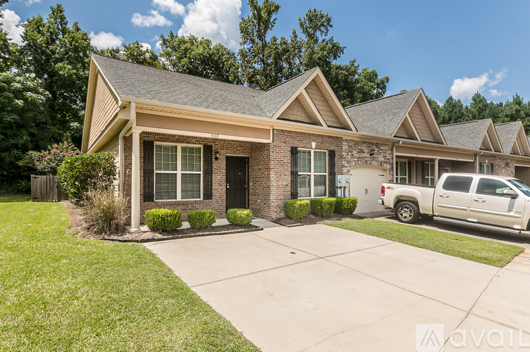 A house with a white pickup truck parked in front.