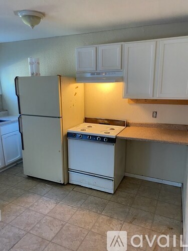 A kitchen with a white refrigerator and a white oven.