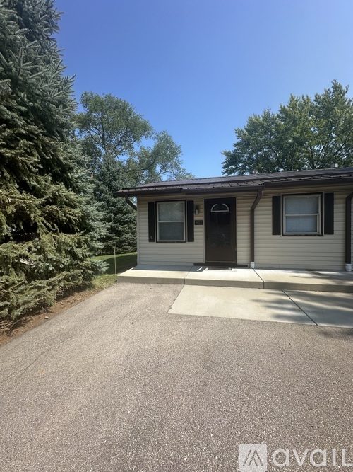 A two-story house with a garage is available for rent.