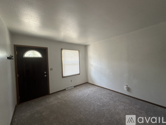 A room with a door and a window is available for rent.